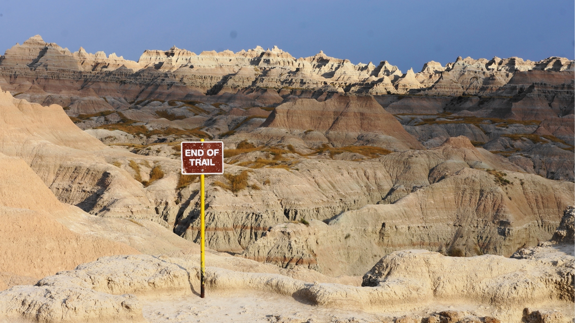 A no trespassing sign stands prominently on a rocky terrain, warning against unauthorized entry.