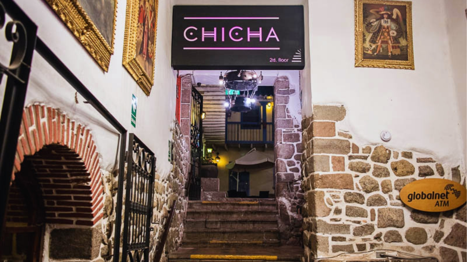 A sign reading "Chicha" displayed on a wall inside a building.