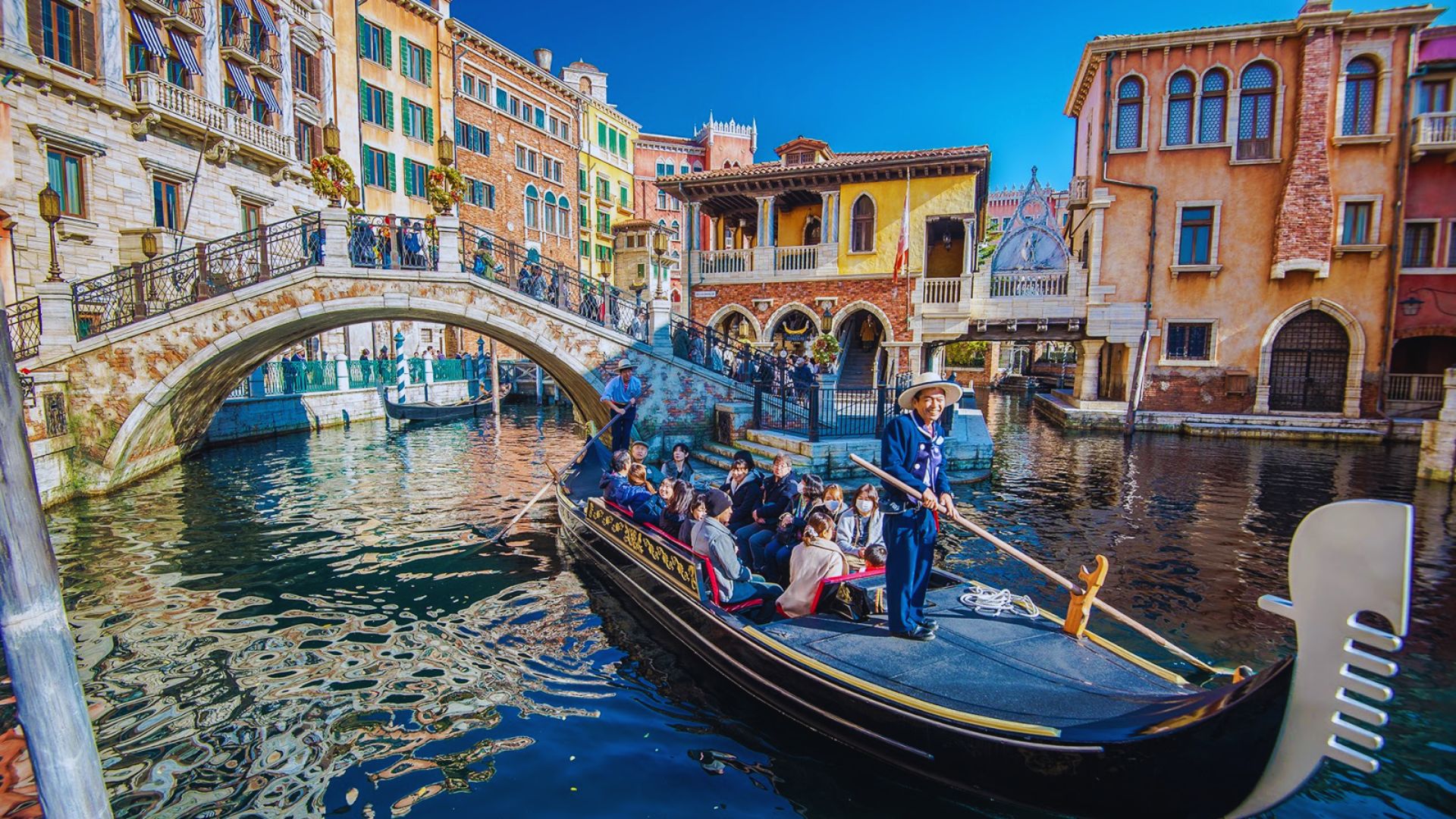 Tourists enjoying a scenic gondola ride through the picturesque canals of Venice, Italy.