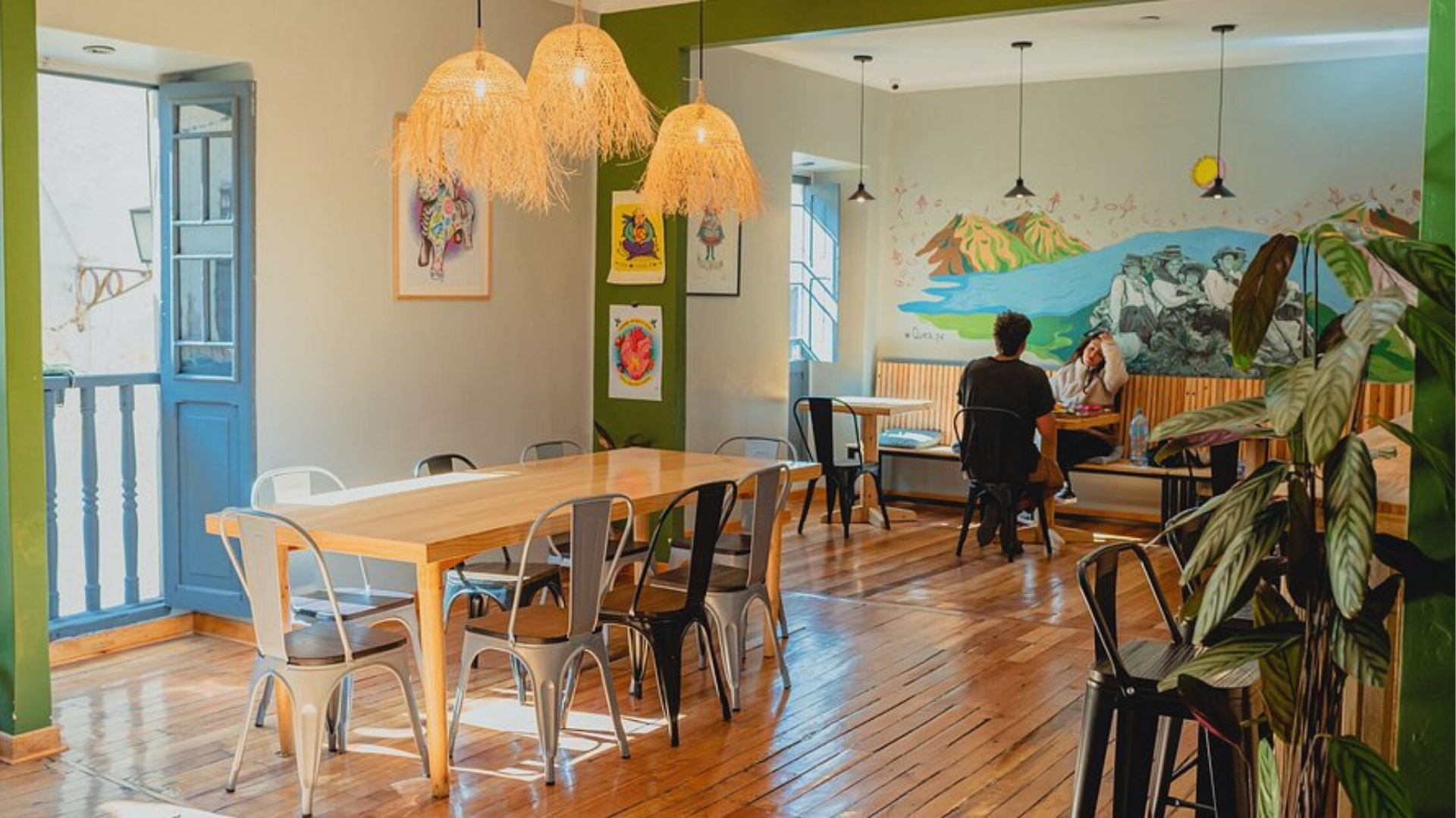A cozy restaurant featuring wooden tables and chairs arranged for dining.