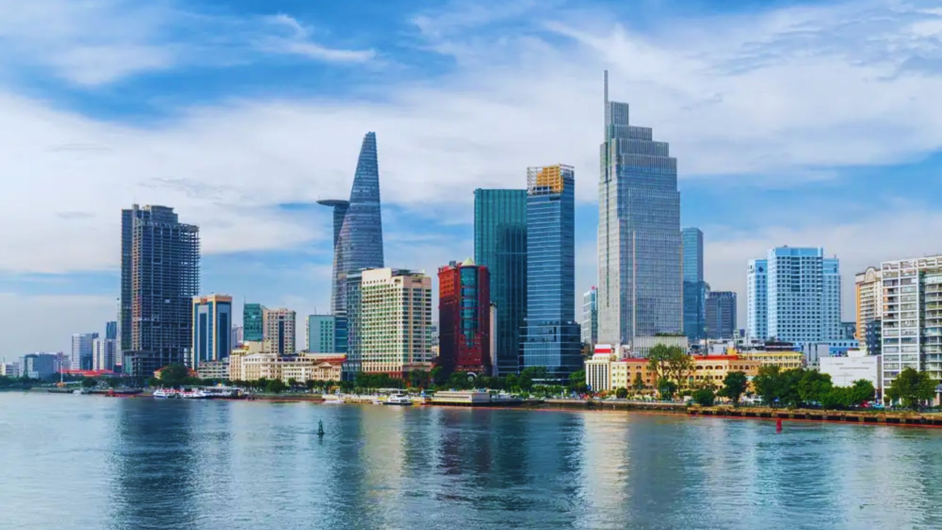 Ho Chi Minh City skyline featuring modern skyscrapers and traditional architecture against a clear blue sky.