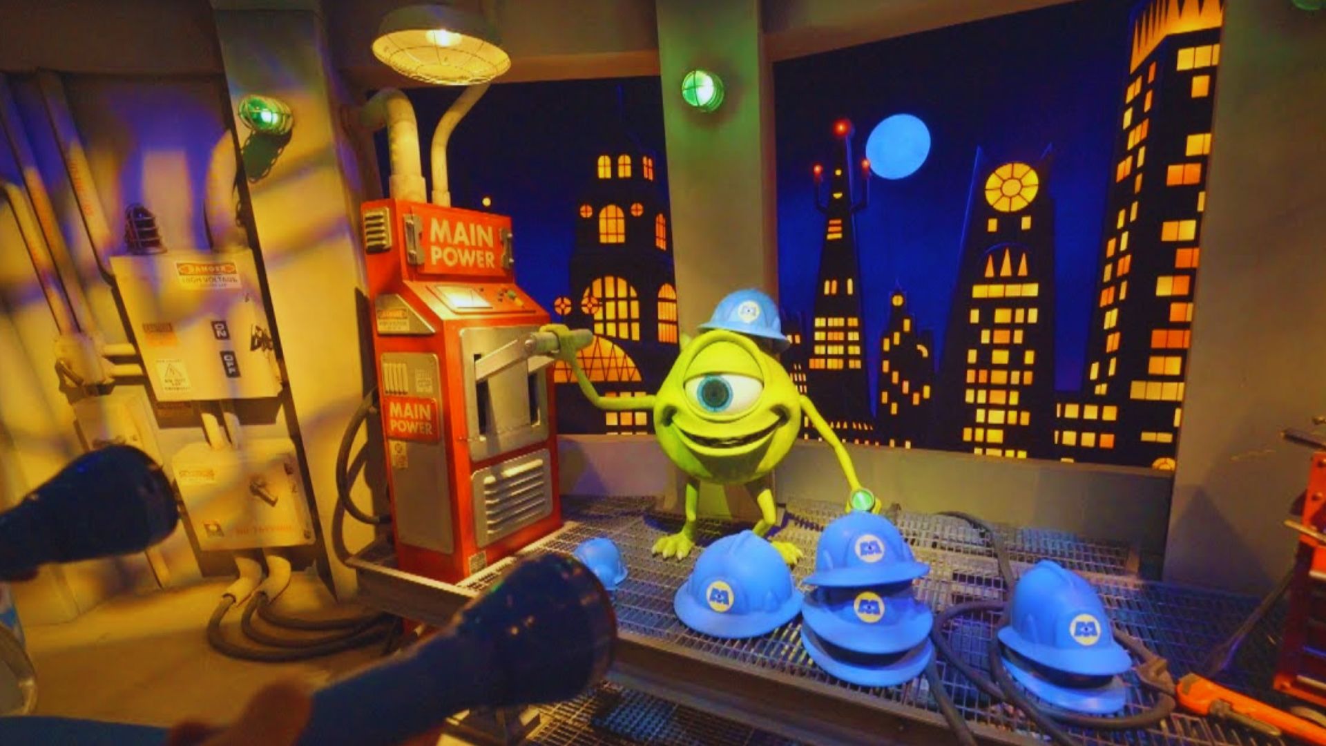 A toy wearing a blue hat, with another blue hat placed beside it.