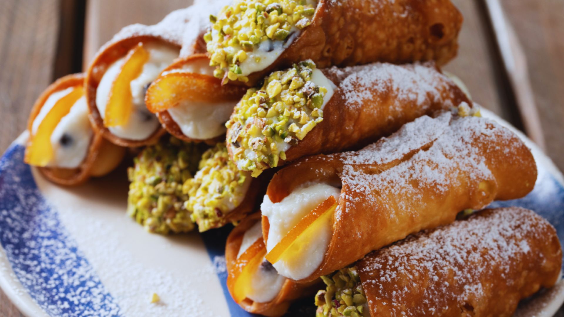 A plate featuring a pastry filled with colorful fruit and creamy filling, elegantly arranged for presentation.