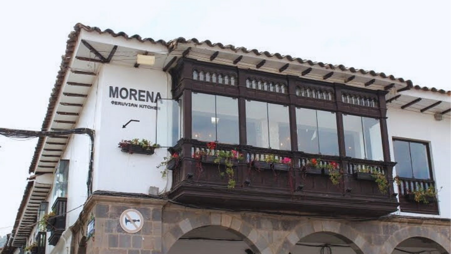 A building featuring a balcony and a sign reading "Morena" prominently displayed on its facade.