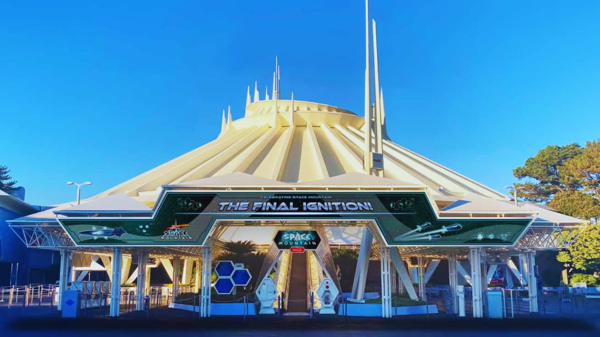 A futuristic hall at Disneyland featuring sleek architecture, vibrant lighting, and interactive displays showcasing innovation.