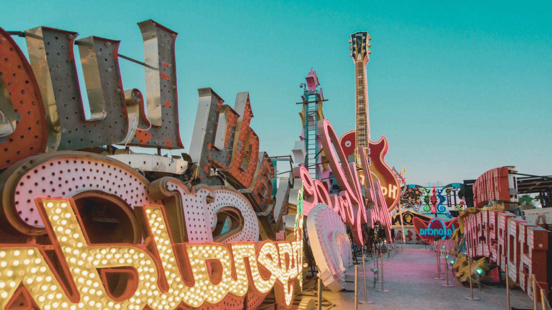 Neon sign featuring a guitar alongside the words "Rock and Roll" in vibrant colors.