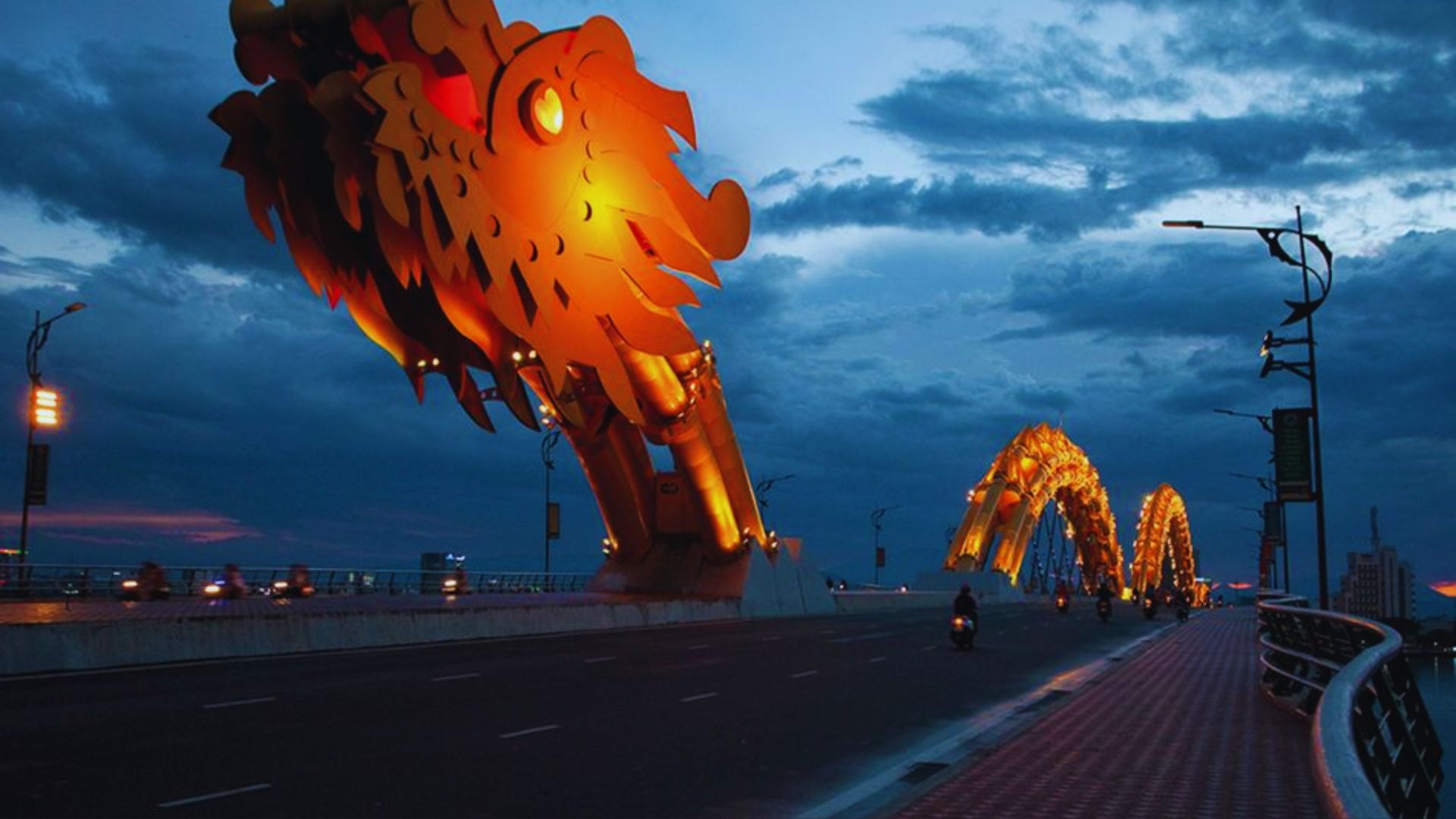 Golden Dragon Bridge in Hoi An, Vietnam, showcasing intricate designs and vibrant colors against a clear blue sky.