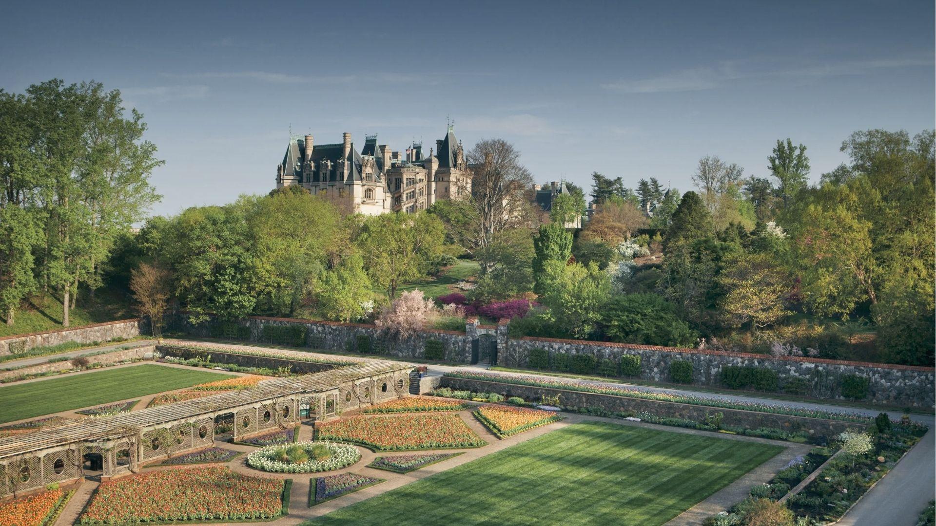Biltmore Estate over manicured gardens and blooming flowerbeds. A magical December holiday estate.