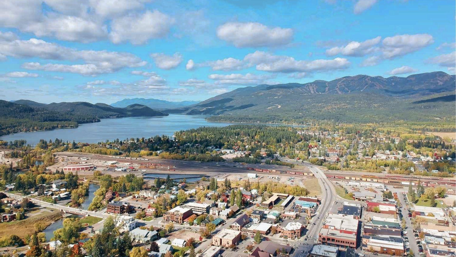 Lakeside town nestled under fall mountains and blue skies. Crisp December air meets serene views.