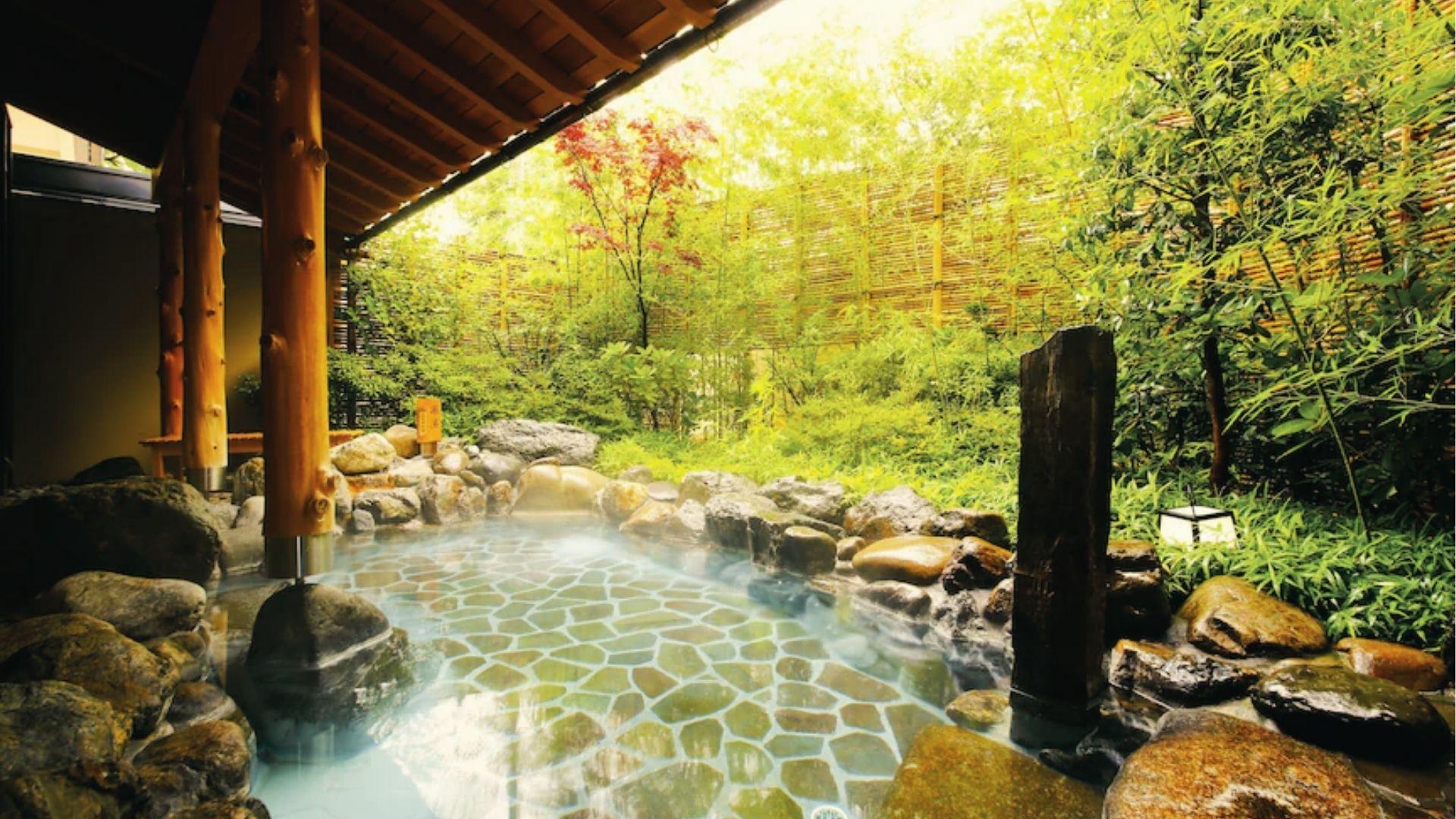 Photograph Kyoto's Kyoto Onsen at dawn, catch cherry blossoms and peaceful water reflections.