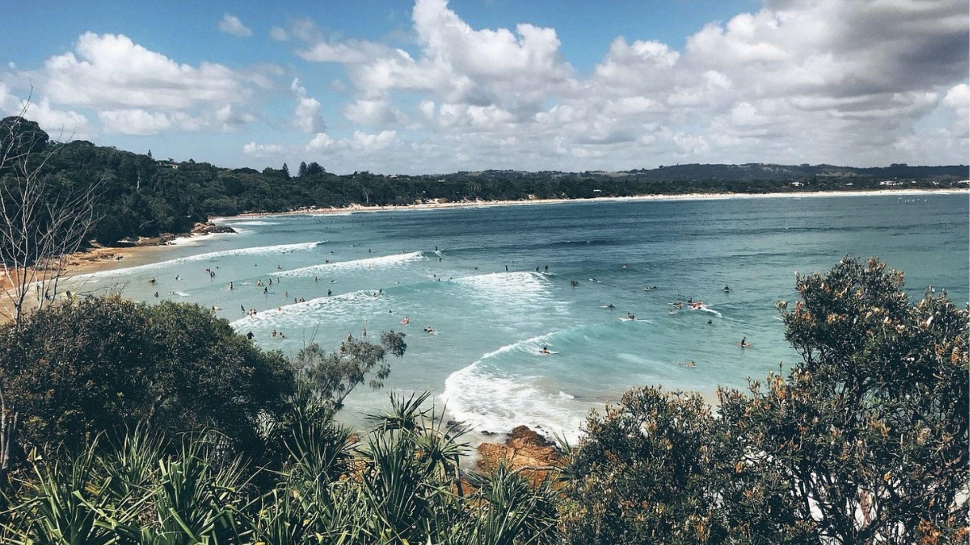 Surf Byron Bay’s main beach with rolling waves, rent boards and watch dolphins at sunrise.