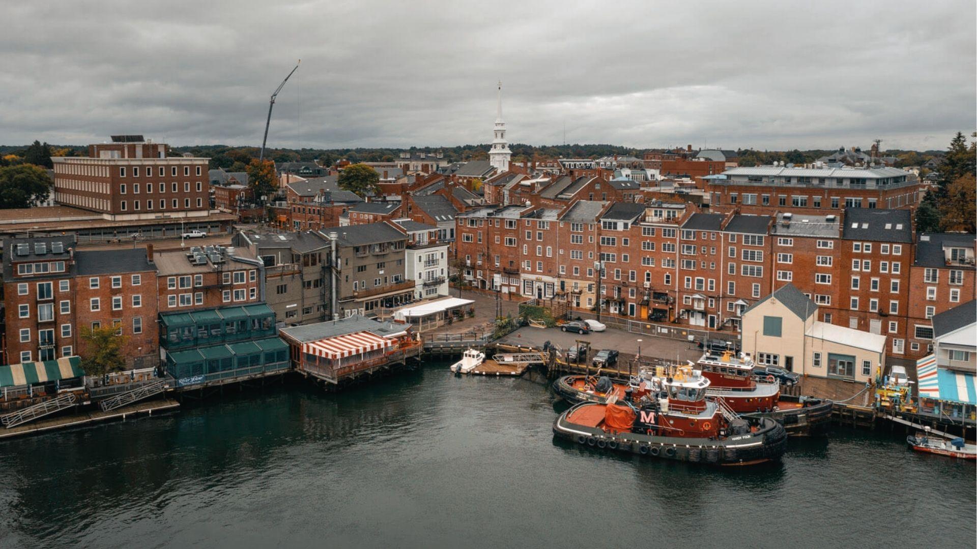 Historic brick waterfront lined with boats and white church steeples. Cozy December coastal charm.