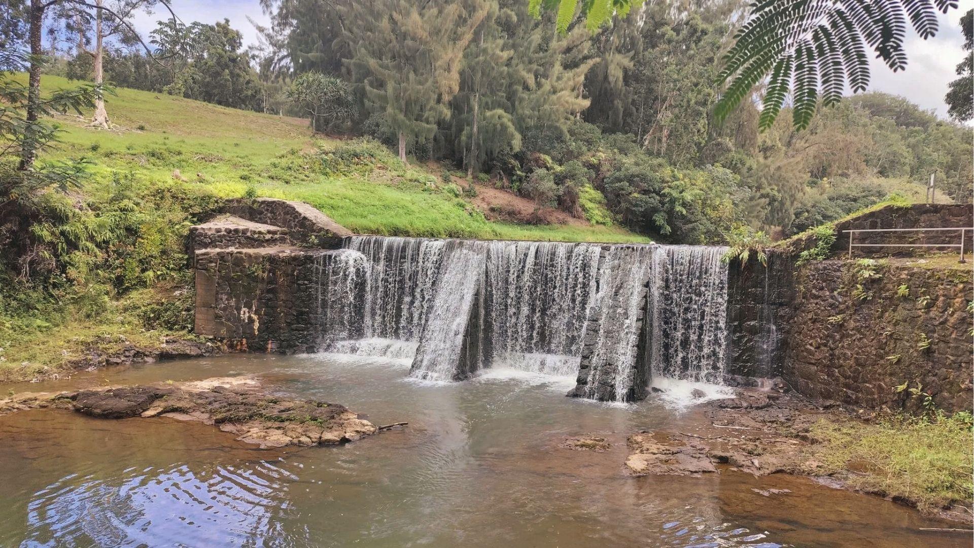 Wai Koa Loop Trail over stone dam into pool, easy hike reward on Kauai's east side.