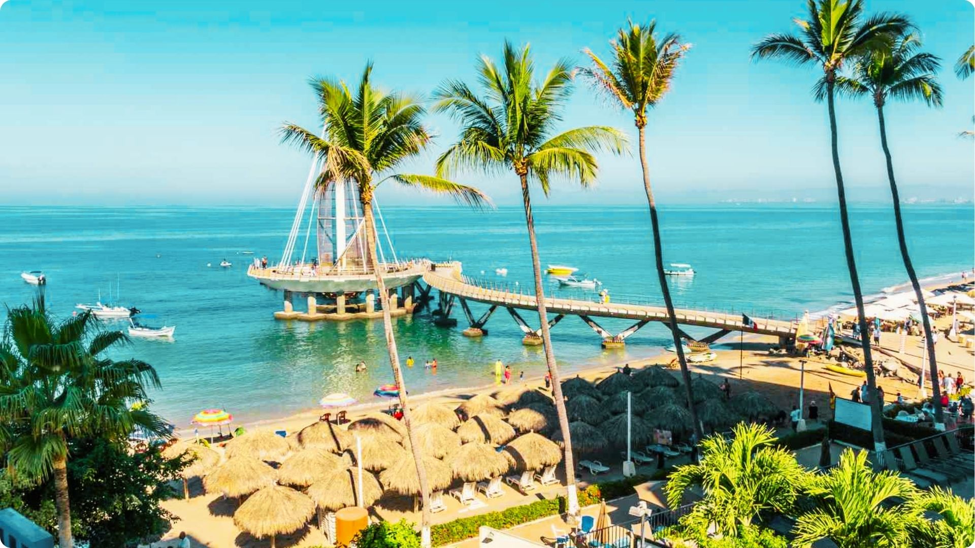 Relax on Playa de los Muertos under palm umbrellas or stroll the iconic sail-shaped pier.